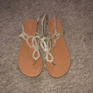 Tan and gold sandals.